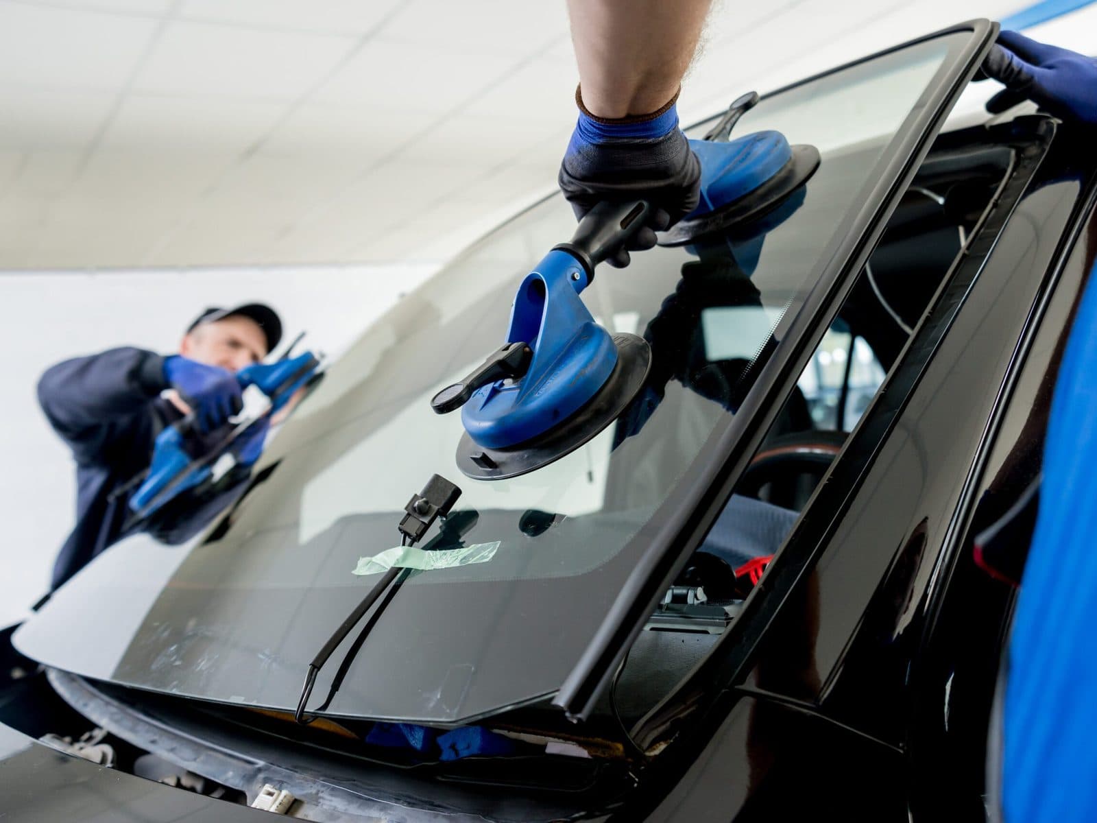 Technician installing a windshield
